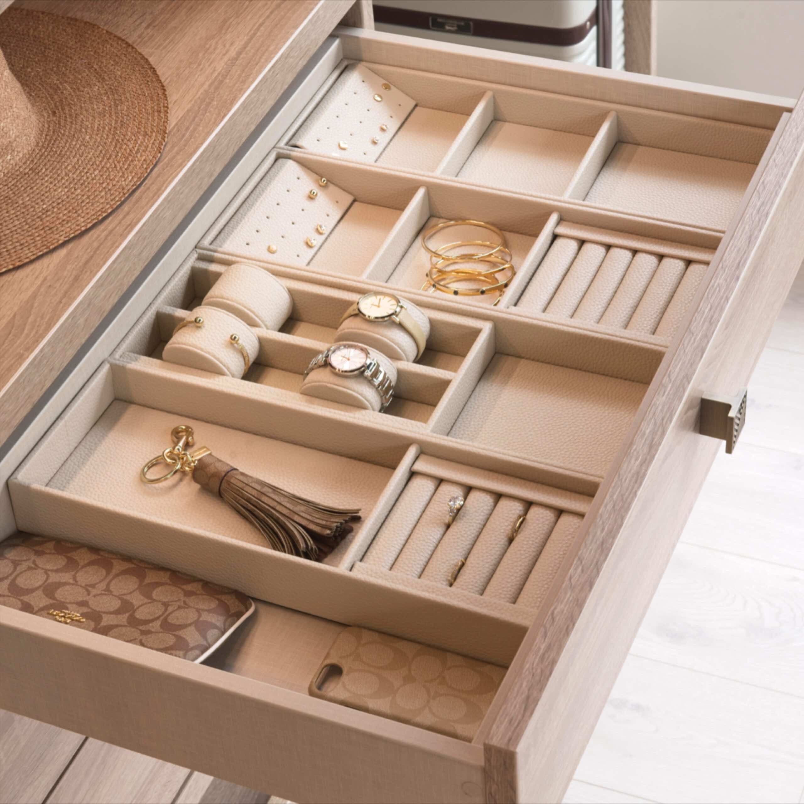 Wardrobe drawer with fitted jewellery inserts holding watches, bracelets and rings