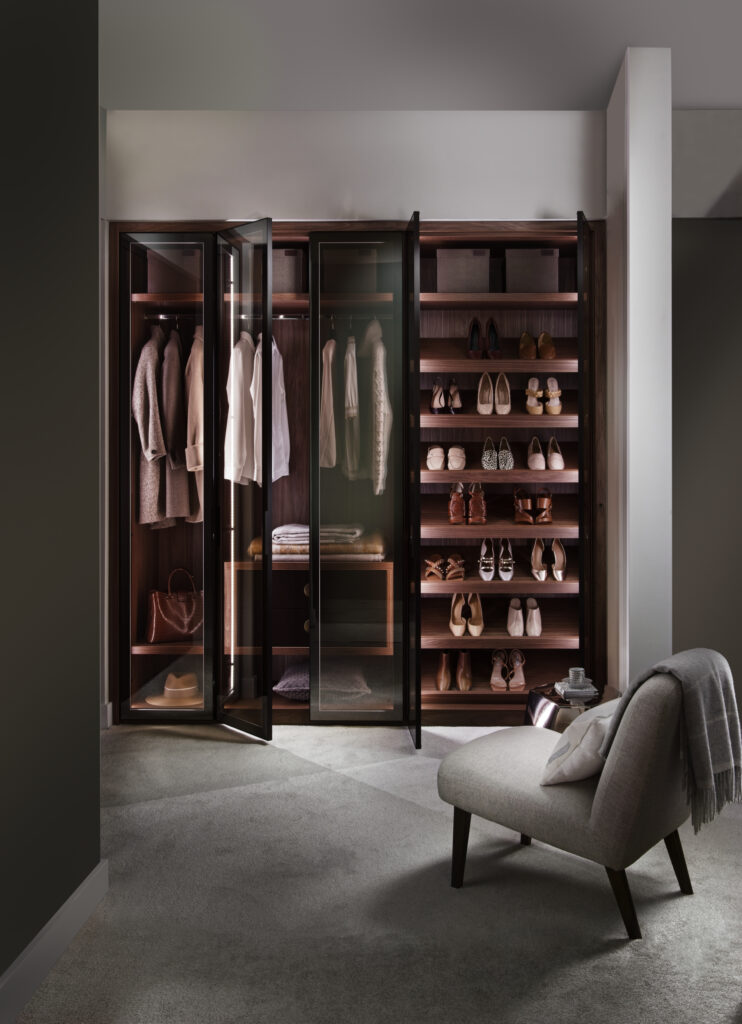 Open door reflex wardrobe with clothes, led lights and angled shoe racks