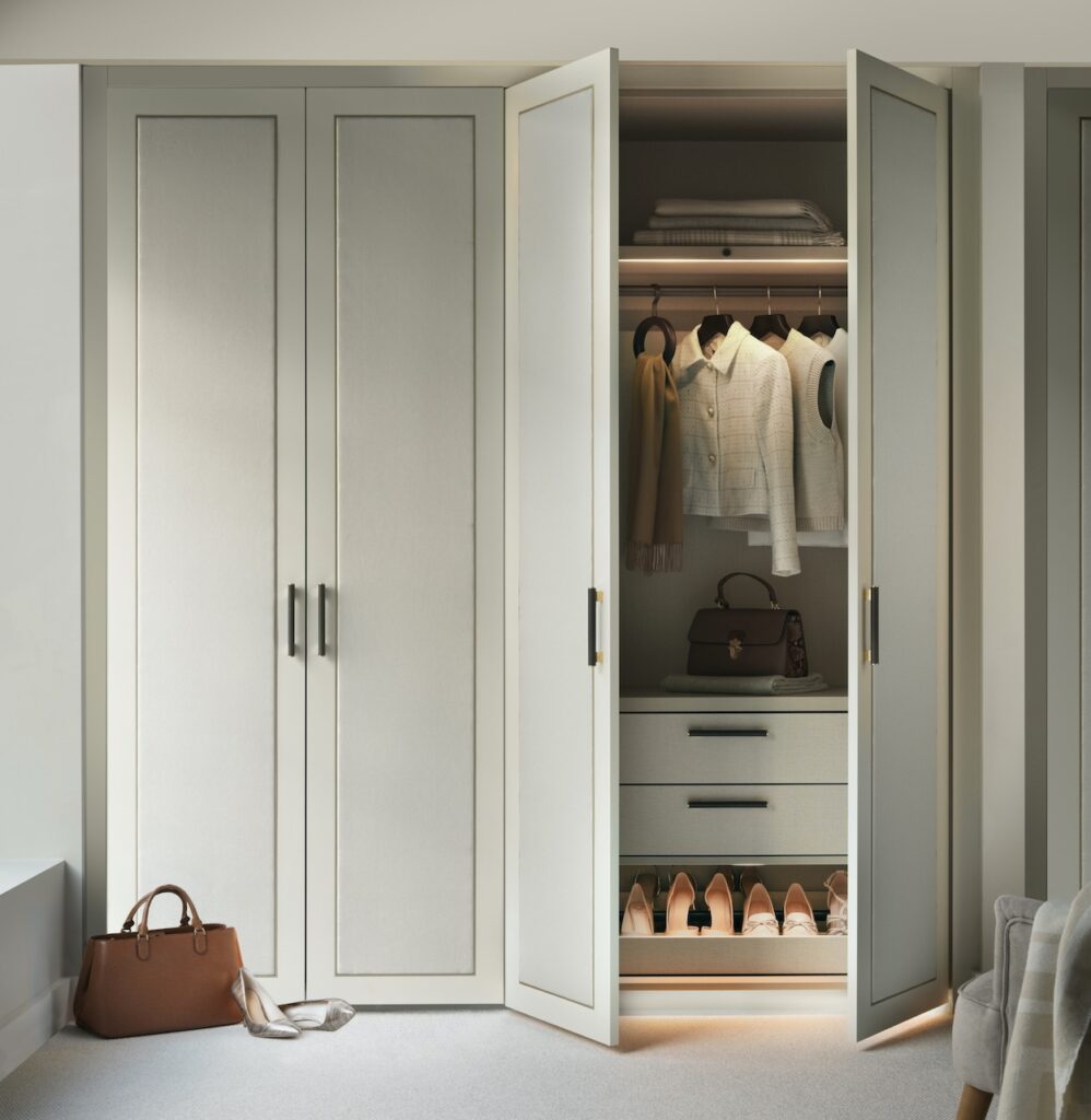 Lifestyle image of doors closed built in wardrobe with bench seat and mirror in grey fabric.