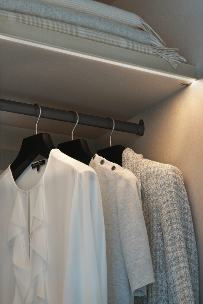 Close up lifestyle of clothing and lighting inside Belgravia style wardrobe